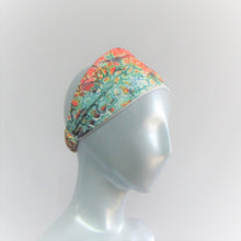 Load image into Gallery viewer, Head band with a mix of jewel tones in a splash pattern. Bamboo cotton forehead liner  and a spandex outer coloured layer. Back neck has a one inch elastic covered in the same fabric. Beach lovers will love this.