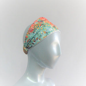 Head band with a mix of jewel tones in a splash pattern. Bamboo cotton forehead liner  and a spandex outer coloured layer. Back neck has a one inch elastic covered in the same fabric. Beach lovers will love this.