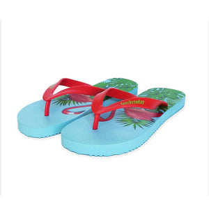 beachcomber flip flops with flamingo standing in leaves with blue background.
