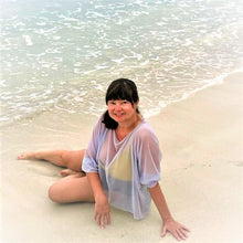 Load image into Gallery viewer, lady relaxing on the beach with a grey coverup on.